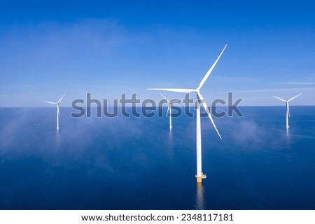 Offshore Windmill farm in the ocean Westermeerwind park , windmills isolated at sea on a beautiful bright day Netherlands Flevoland Noordoostpolder Royalty-Free Stock Photo #2348117181