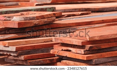 Many Padauk Wood planks Stacked in industrial yard area, wood construction Material background, close up shot Royalty-Free Stock Photo #2348127615