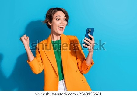 Photo of young girl influencer worker raise fist up hooray receive sms her boss chance get promoted isolated on blue color background Royalty-Free Stock Photo #2348135961
