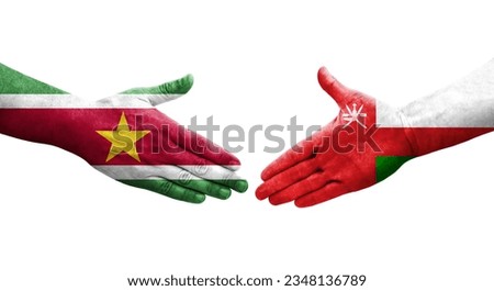 Handshake between Oman and Suriname flags painted on hands, isolated transparent image.