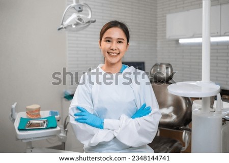 Young  asian  female dentist looking at camera in dental office.Close up potrait of the doctor woman at white clinic.  Royalty-Free Stock Photo #2348144741