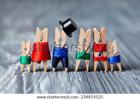 Family portrait. Concept. Playground family. Abstract: The family of linen clothespins. Man, woman with child. Man, woman, child in swimwear. (Soft focus).