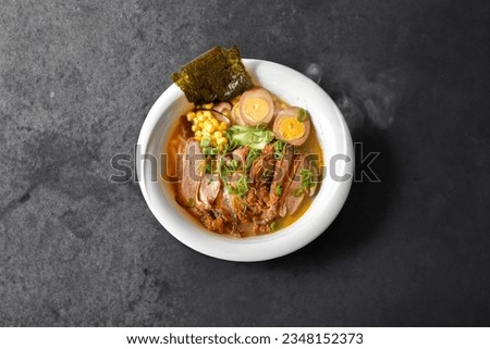 Fresh steamed beef ramen noodle soup served with egg and pak choi, corn, nori, beef stock and spring onion. Japanese soup