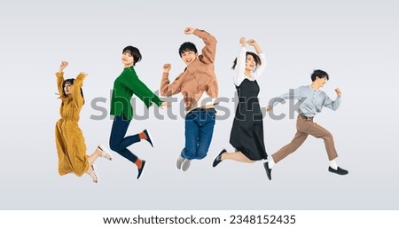 A group of  jumping young people on colorful background. Royalty-Free Stock Photo #2348152435