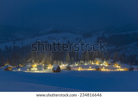 Small village in the snowy mountains in winter night