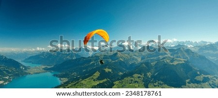 Paragliding over the Swiss Alps       Royalty-Free Stock Photo #2348178761