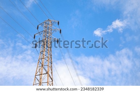 overhead power lines depict vital electric power transmission, linking communities and driving progress. Symbolic of energy flow and connectivity,  Royalty-Free Stock Photo #2348182339