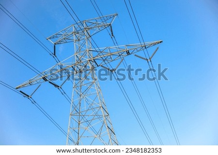 overhead power lines depict vital electric power transmission, linking communities and driving progress. Symbolic of energy flow and connectivity, 