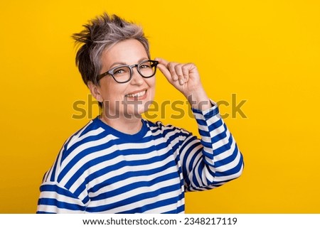 Portrait of attractive nice old woman grey short haircut touch eyeglasses posing business leader isolated on yellow color background Royalty-Free Stock Photo #2348217119