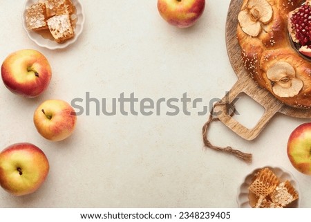 Jewish Holidays - Rosh Hashanah or Rosh Hashana. Pomegranate, apples, honey and round challah on rustic grey table background. Jewish Autumn celebration. Shana Tova. Yom kippur concept. Top view. 