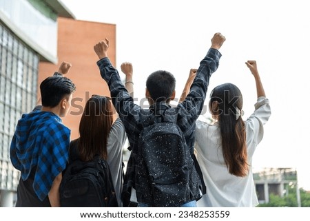 Group of happy young entrepreneurs with hands up and laughing to celebrate and excited success for achievements obtained. Undergraduate students celebrate success after end project, teamwork concept Royalty-Free Stock Photo #2348253559