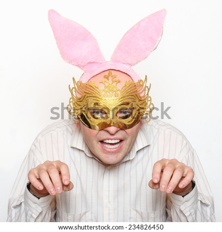 Funny picture of man in love with paper mask and rabbit ears. 