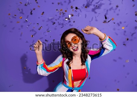 Photo of energetic active lady dancing moving on holiday with flying confetti isolated on violet color background Royalty-Free Stock Photo #2348273615