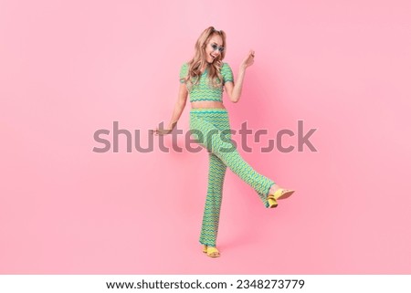Full size photo of attractive young woman enjoy summer party dancer dressed stylish green print clothes isolated on pink color background