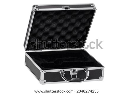 Closeup of a opened empty small black silver equipment case or suitcase with a latch isolated on a white background. Clipping path.