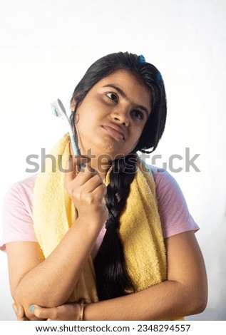 An Indian woman female girl with toothbrush looking sideways on white background