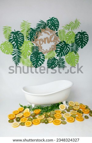 the milk bath is decorated with tropical fruits. bath for taking pictures of children