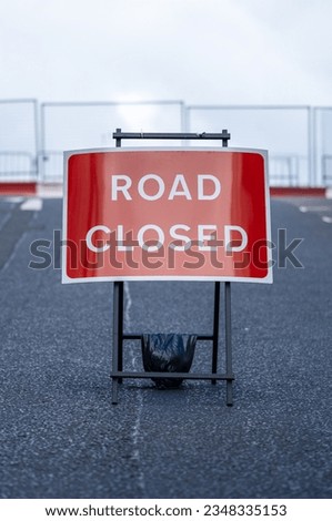 A Road Closed Sign In An Empty Urban Street