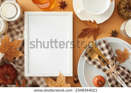 Heartwarming thanksgiving gathering idea. Top view photo of plates, cutlery, glass, teacup, candles, tablecloth, autumnal decorations on pastel brown background with empty frame for advert or text
