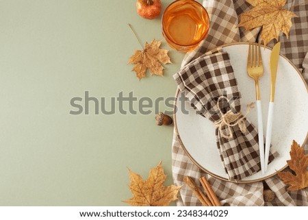 Thanksgiving gathering idea. Top view photo of plate, cutlery, glass, checkered napkin, tablecloth, autumnal decorations on olive background with empty space for promo or text