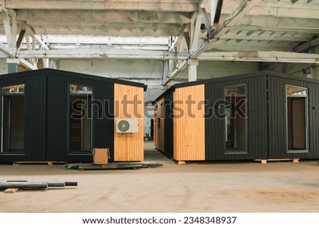 A new wooden modular prefabricated house inside an industrial building Royalty-Free Stock Photo #2348348937