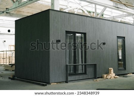 Exhibition of new and modern prefabricated modular house from composite wood panels. Energy efficient panel assembling Royalty-Free Stock Photo #2348348939
