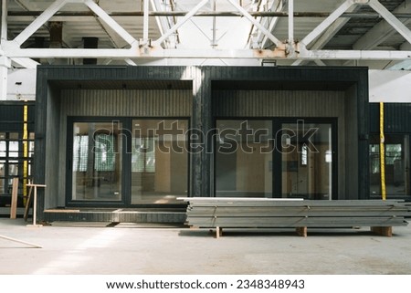 A new wooden modular prefabricated house inside in manufacturing facility Royalty-Free Stock Photo #2348348943