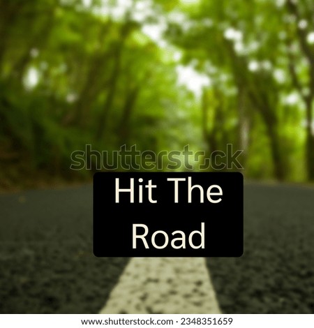 Composite of hit the road text over road and forest landscape. Road, travel, vacation and journey concept digitally generated image.