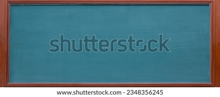 Empty green chalkboard texture hang on the white wall. double frame from green board and white background. image for background, wallpaper and copy space. bill board wood frame for add text. Royalty-Free Stock Photo #2348356245