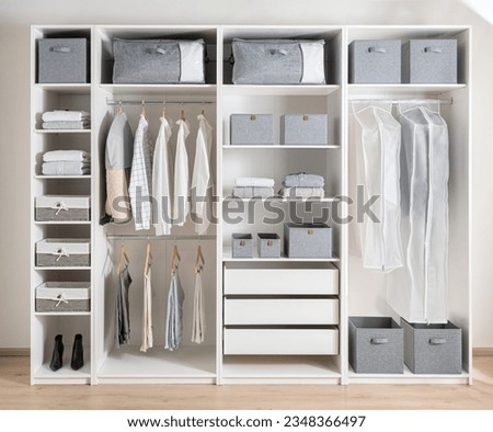 Closet with different clothes and accessories, Clothing Cover in a modern white wardrobe Organizer inside a modern room Royalty-Free Stock Photo #2348366497