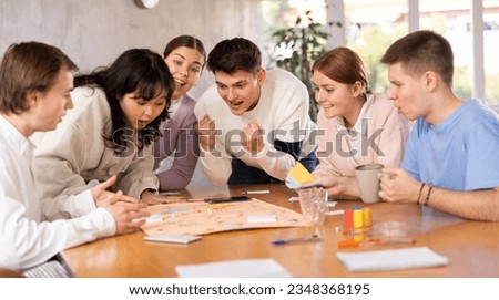 Happy girls and boys play board games in classroom Royalty-Free Stock Photo #2348368195