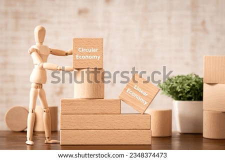 There is wood cube with the word Circular Economy or Linear Economy. It is as an eye-catching image. Royalty-Free Stock Photo #2348374473