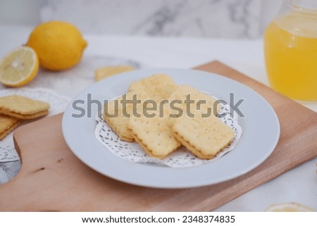 Crispy crackers and lemon juice on a white background.