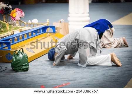 Sikh Man doing Matha Tek and Bowing To Guru Granth Sahib Ji At the San Jose Gurdwara. Its a Religious place for Sikhs to Bow to the Guru. Royalty-Free Stock Photo #2348386767
