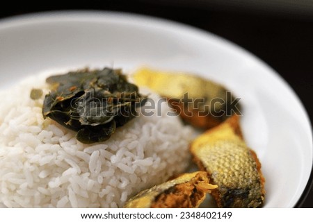 Cooked Milkfish and Moringa Leaf Soup served with White Rice Isolated Photo
