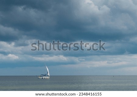 White clouds in the blue sky over the sea horizon