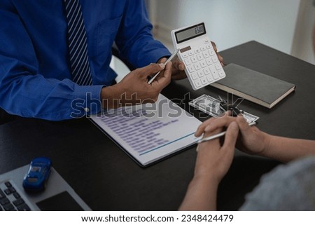 Signing a car insurance document or a rental agreement or agreement. Buy or sell a new or used car with car keys on the table in the office. close up pictures