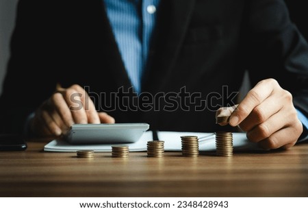 Businessman calculates investment income, financial business investments analyze risks, research companies, consult experts, plan wisely for financial goals. insurance companies, mutual funds, stocks Royalty-Free Stock Photo #2348428943