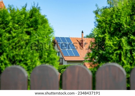 House roof with photovoltaic modules. Historic farm house with modern solar panels on roof and wall High quality photo Royalty-Free Stock Photo #2348437191