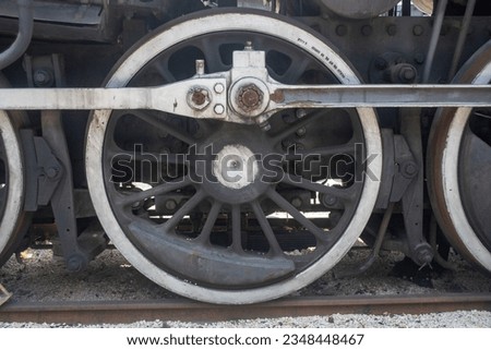 Huge wheel of an old steam locomotive on the rails
 Royalty-Free Stock Photo #2348448467