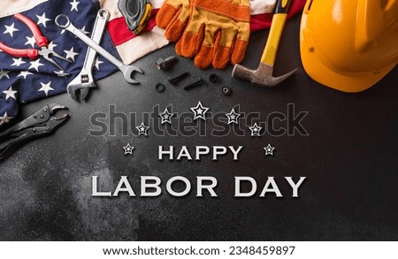 Happy Labor day concept. American flag with different construction tools and the text on dark background. Royalty-Free Stock Photo #2348459897