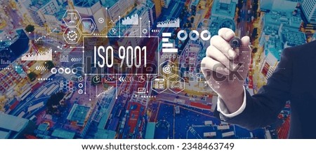 ISO 9001 theme with businessman in a city at night
