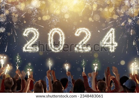 Happy new year. Crowd watching fireworks. Parents and kids celebrate new 2024 year. Winter holiday party. Outdoor fun. Happy group of friends with sparkler watch firework show. Royalty-Free Stock Photo #2348483061