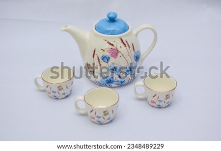 Mock up design- set of elegant and traditional tea set teapot colorful white and blue coffee cup and Tea cup on cup's plate beside the hot tea pot , design- drink-ware isolated on white background Royalty-Free Stock Photo #2348489229