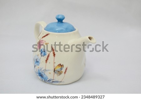 Mock up design- set of elegant and traditional tea set teapot colorful white and blue coffee cup and Tea cup on cup's plate beside the hot tea pot , design- drink-ware isolated on white background Royalty-Free Stock Photo #2348489327