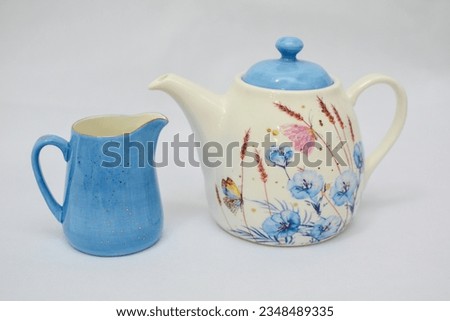 Mock up design- set of elegant and traditional tea set teapot colorful white and blue coffee cup and Tea cup on cup's plate beside the hot tea pot , design- drink-ware isolated on white background Royalty-Free Stock Photo #2348489335