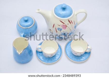 Mock up design- set of elegant and traditional tea set teapot colorful white and blue coffee cup and Tea cup on cup's plate beside the hot tea pot , design- drink-ware isolated on white background Royalty-Free Stock Photo #2348489393