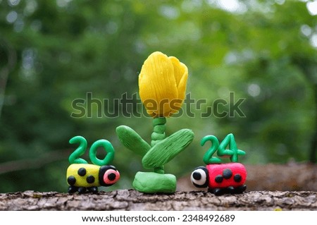 Two ladybugs and the number 2024. A festive event. Calendar date.