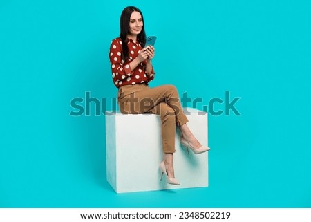 Full size portrait of elegant stunning girl sit podium use smart phone texting isolated on turquoise color background