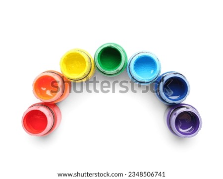 Open jars of colorful gouache paints on white background
